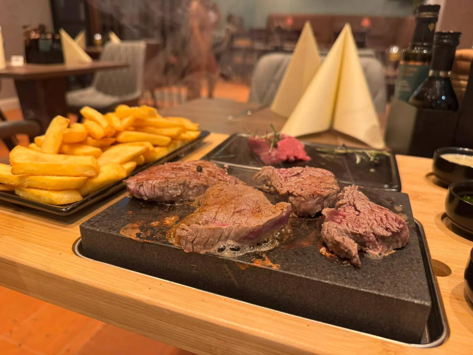 Steak brutzelt auf heißem Stein am Tisch im Ratskeller Tübingen